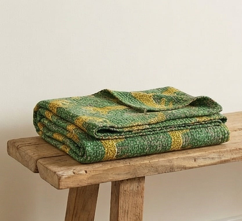 Patterned handmade Indian kantha throw used as a decorative textile layer