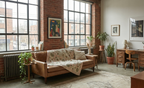 Cozy living room with a brown sofa, large windows, and brick walls.