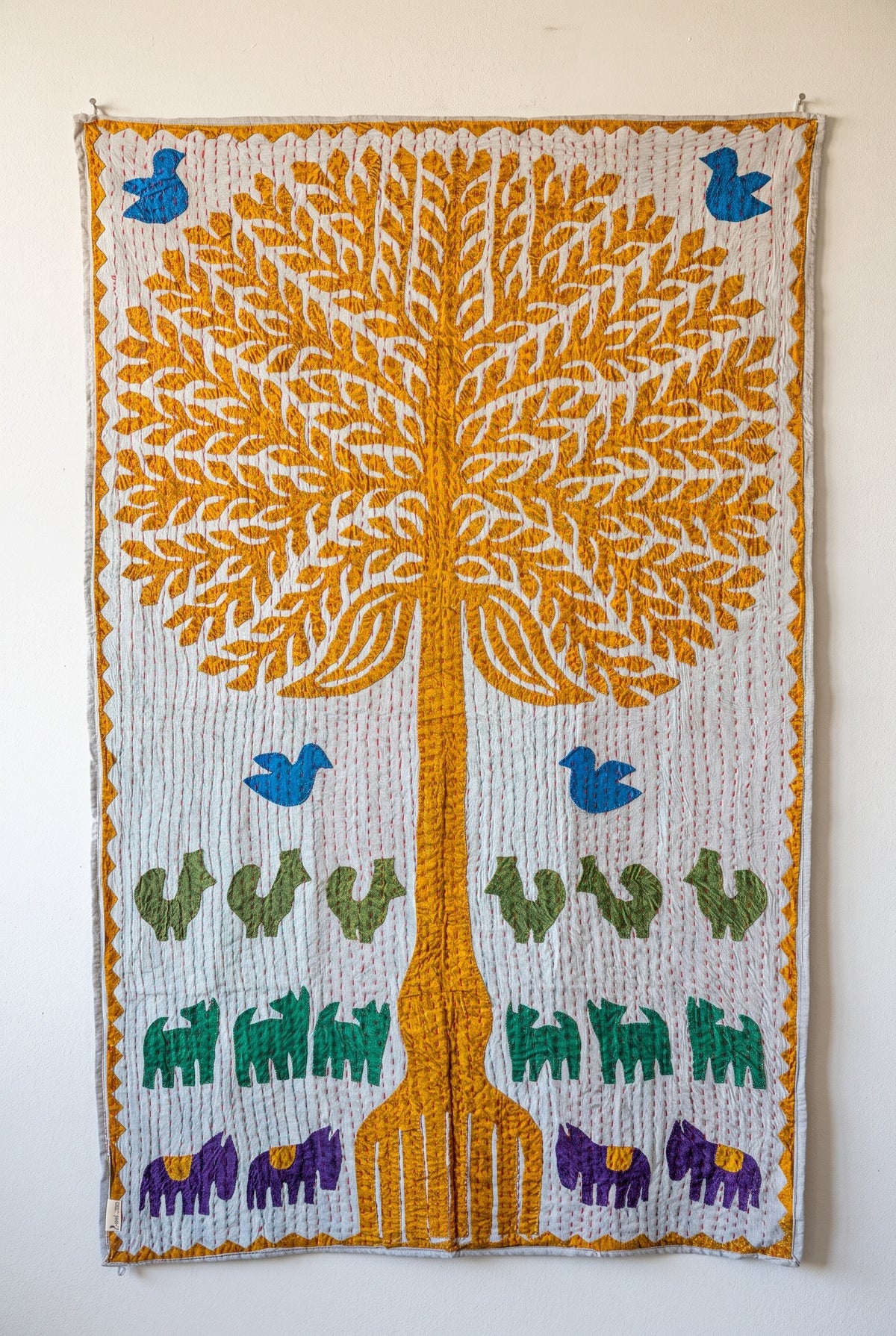 Serene Lotus Kantha Appliqué Pure Cotton Wall Hanging — full hanging in studio view