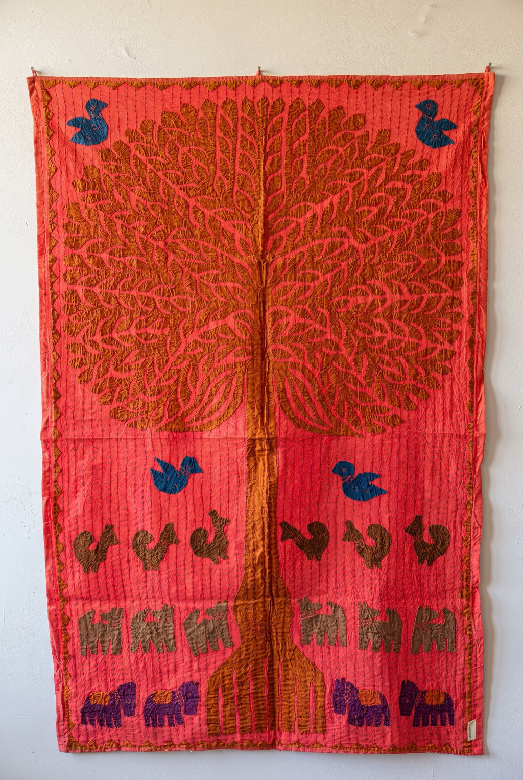 Sylvan Maple Kantha Appliqué Pure Cotton Wall Hanging — full hanging in studio view