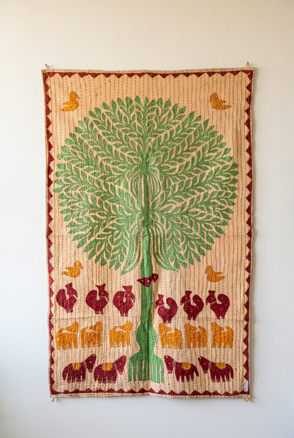 Serene Dawn Kantha Appliqué Pure Cotton Wall Hanging — full hanging in studio view