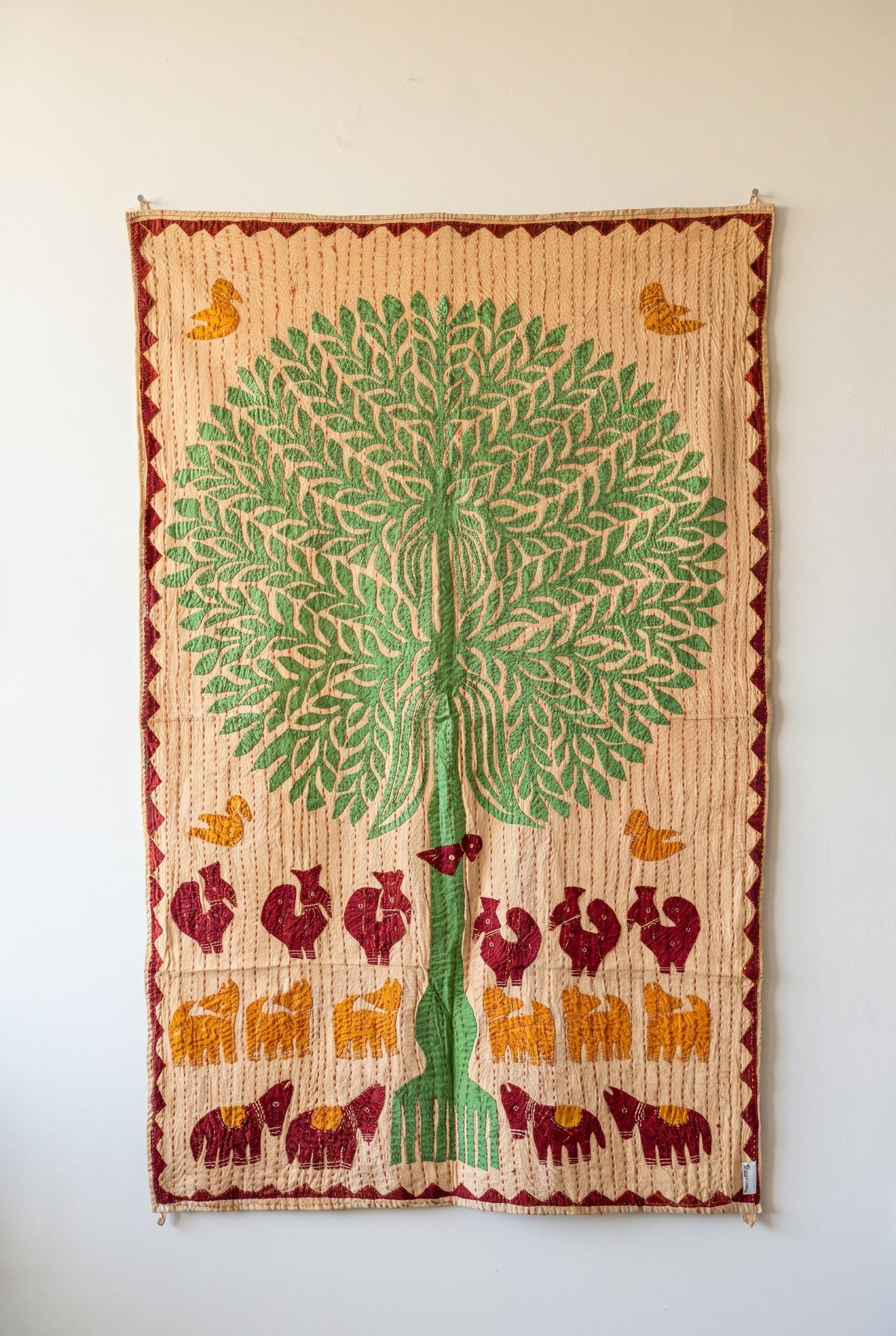 Serene Dawn Kantha Appliqué Pure Cotton Wall Hanging — full hanging in studio view