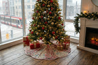 Decorative tree skirt with Christmas tree and presents in a living room setting.
