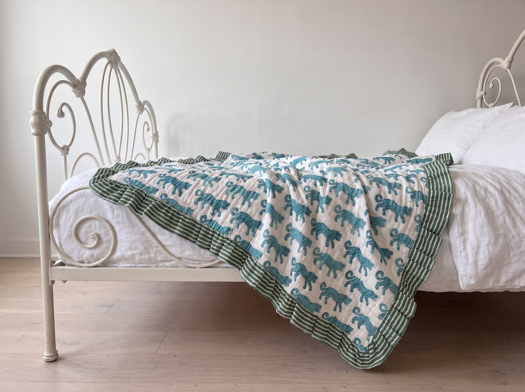 Elephant Meadow reversible cotton baby blanket, side one, iron bed