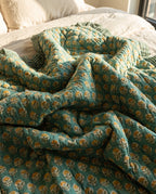 Elephant Meadow reversible cotton baby blanket, side two, bed editorial