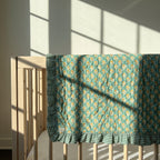 Elephant Meadow reversible cotton baby blanket, side two, crib rail