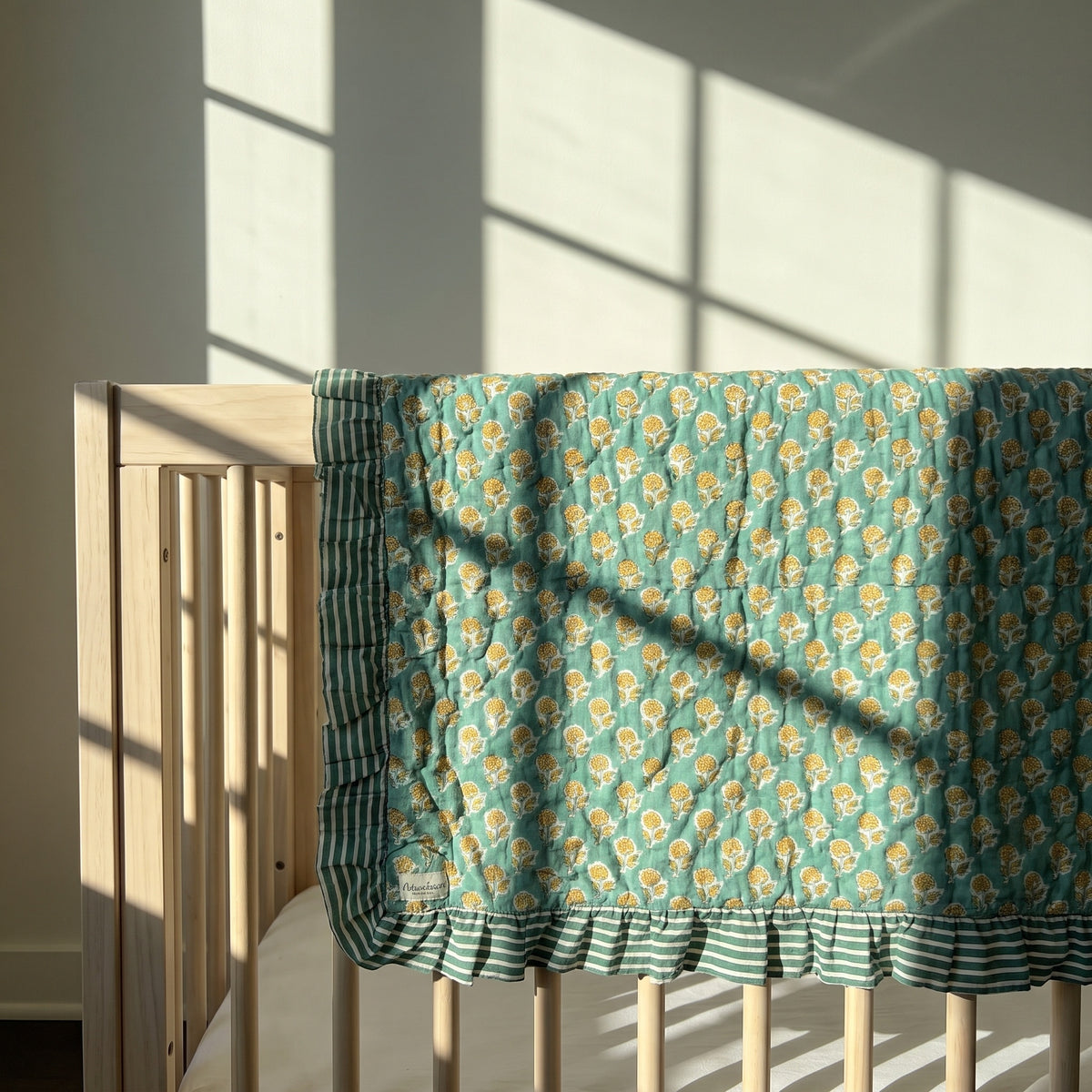 Elephant Meadow reversible cotton baby blanket, side two, crib rail