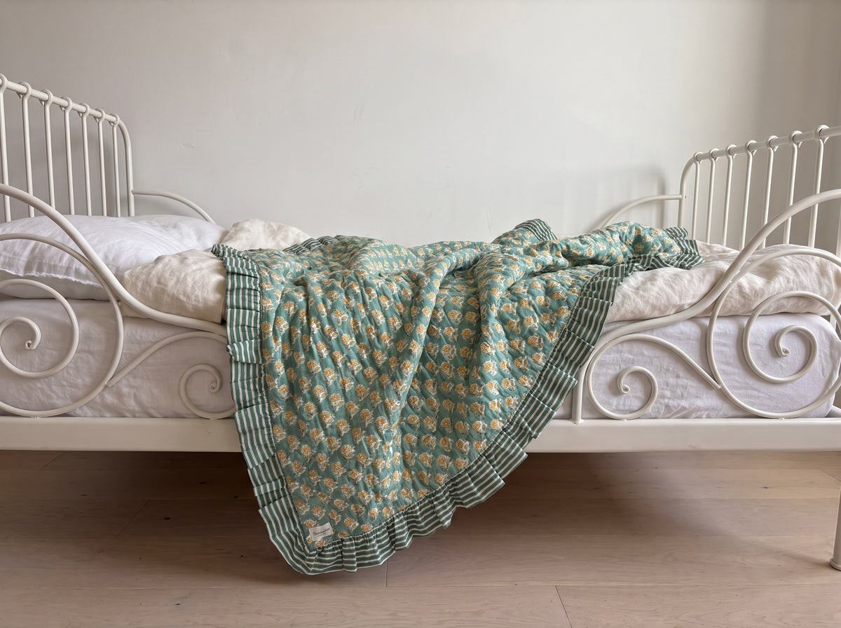 Elephant Meadow reversible cotton baby blanket, side two, iron bed