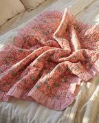 Petal Play reversible cotton baby blanket, side one, bed editorial