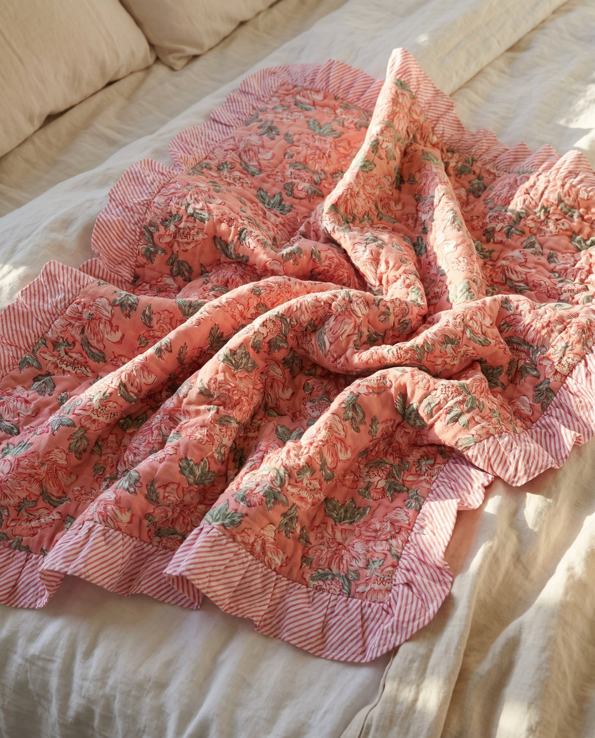 Petal Play reversible cotton baby blanket, side one, bed editorial
