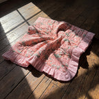 Petal Play reversible cotton baby blanket, side one, floor