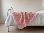 Petal Play reversible cotton baby blanket, side one, iron bed