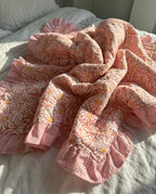 Petal Play reversible cotton baby blanket, side two, bed editorial