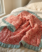 Garden Stories reversible cotton baby blanket, side one, bed editorial