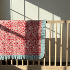 Garden Stories reversible cotton baby blanket, side one, crib rail