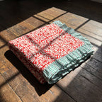 Garden Stories reversible cotton baby blanket, side one, floor