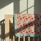 Garden Stories reversible cotton baby blanket, side two, crib rail