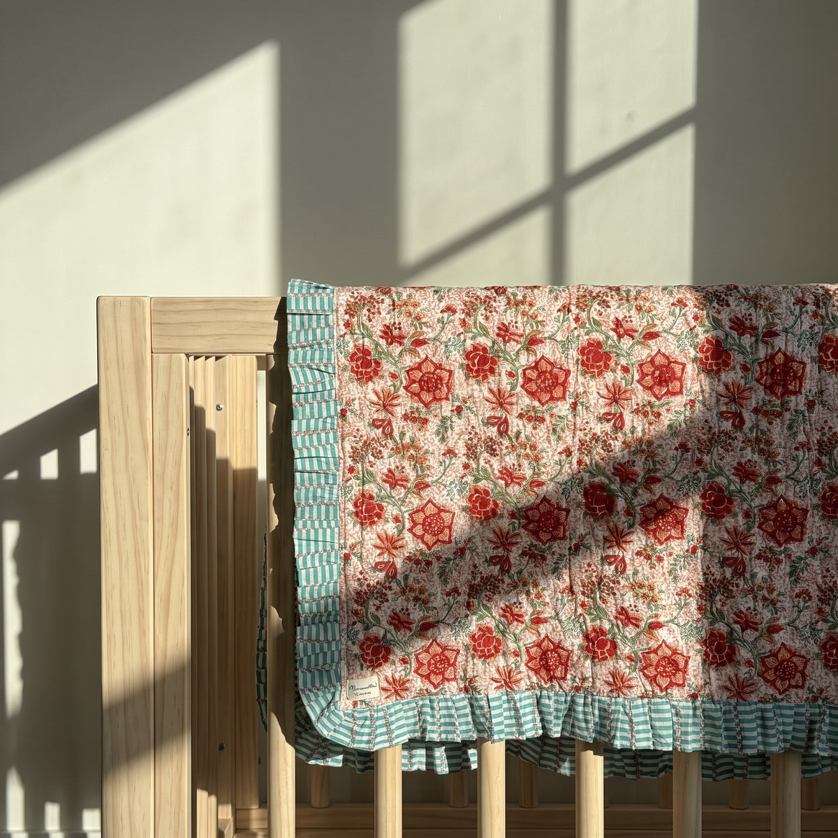 Garden Stories reversible cotton baby blanket, side two, crib rail