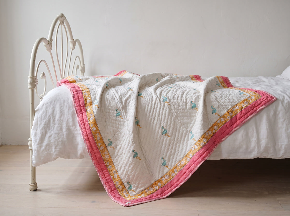 Flamingo Daydreams reversible cotton baby blanket, side one, iron bed