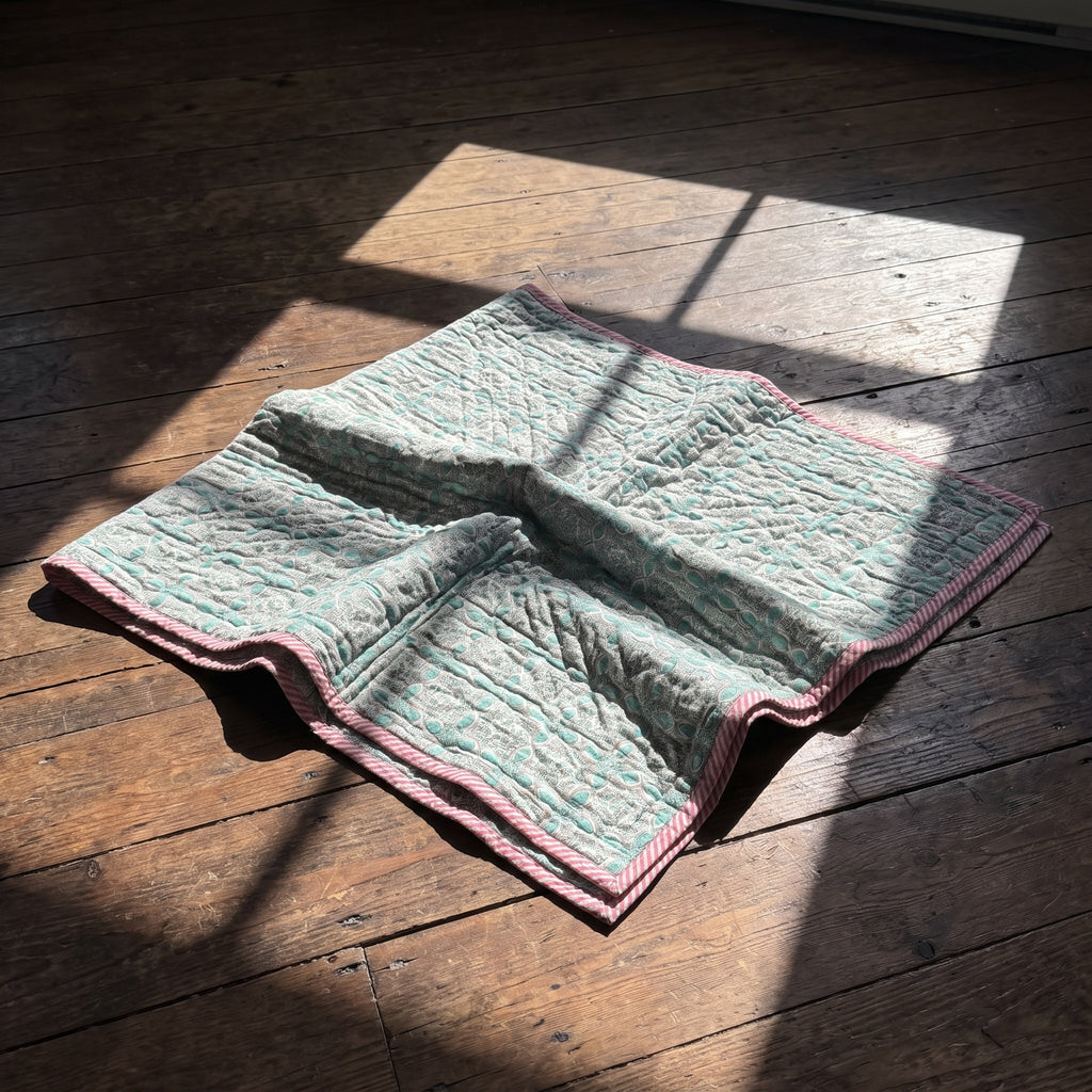 Flamingo Daydreams reversible cotton baby blanket, side two, floor