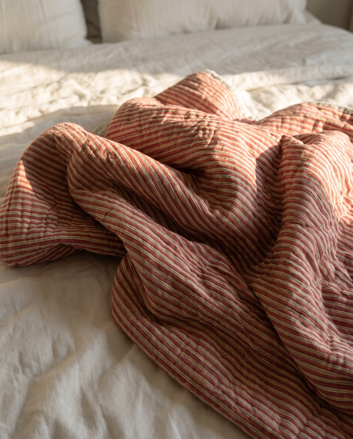 Puppy Promenade reversible cotton baby blanket, side one, bed editorial
