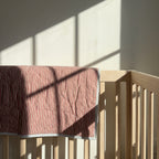 Puppy Promenade reversible cotton baby blanket, side one, crib rail