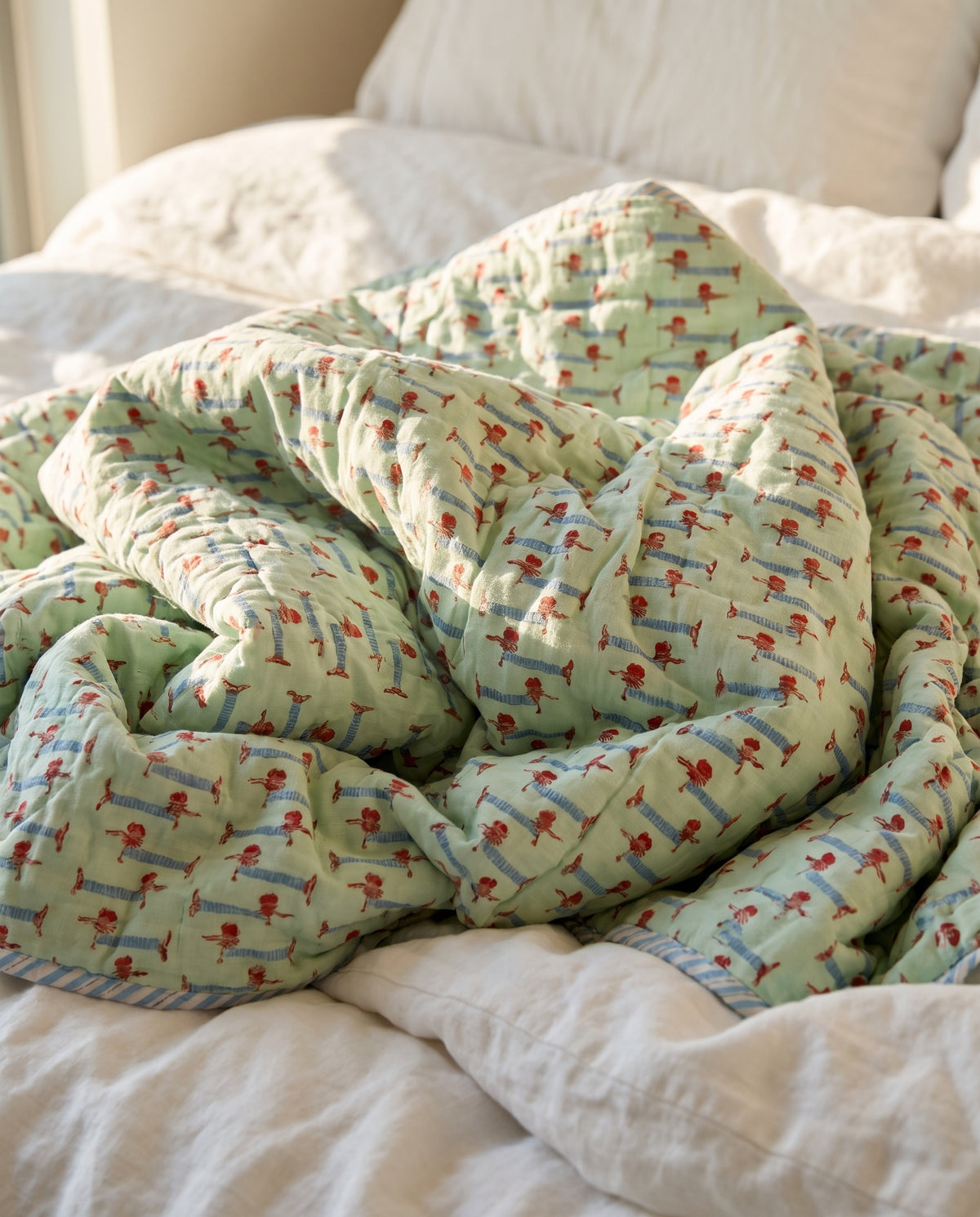 Puppy Promenade reversible cotton baby blanket, side two, bed editorial