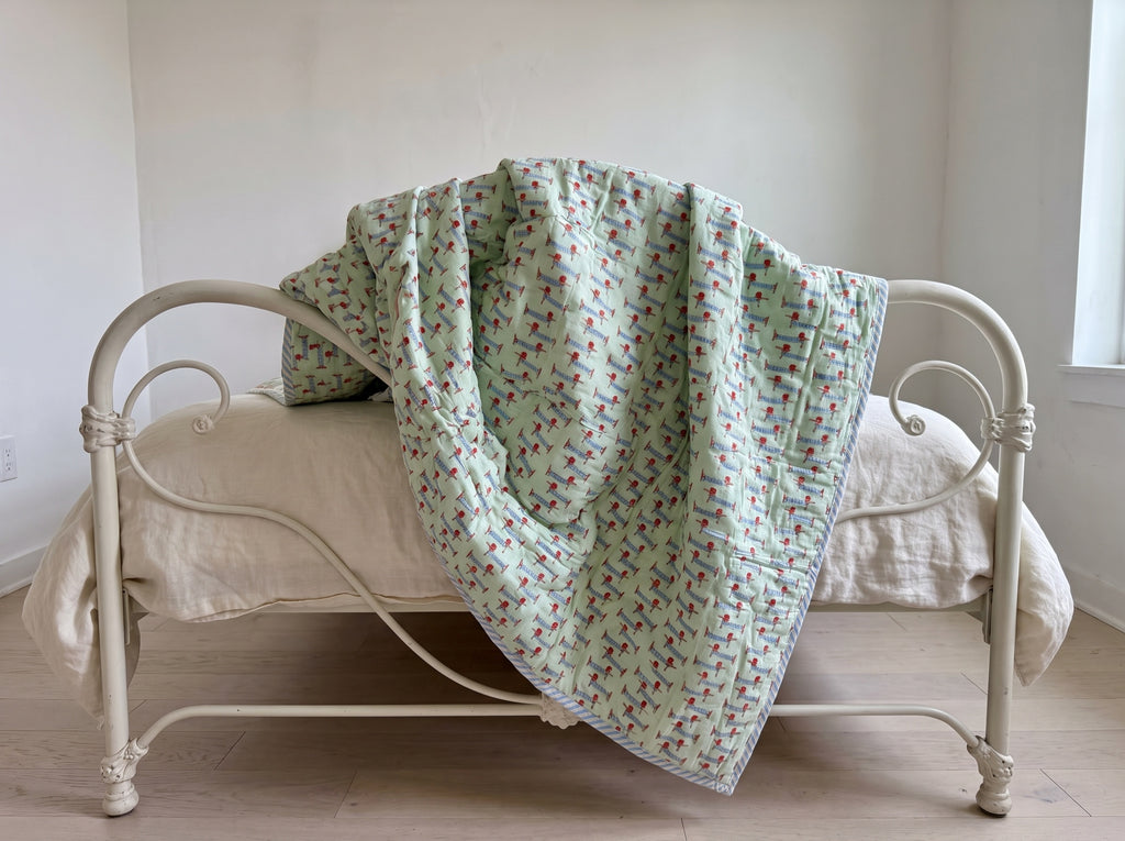 Puppy Promenade reversible cotton baby blanket, side two, iron bed