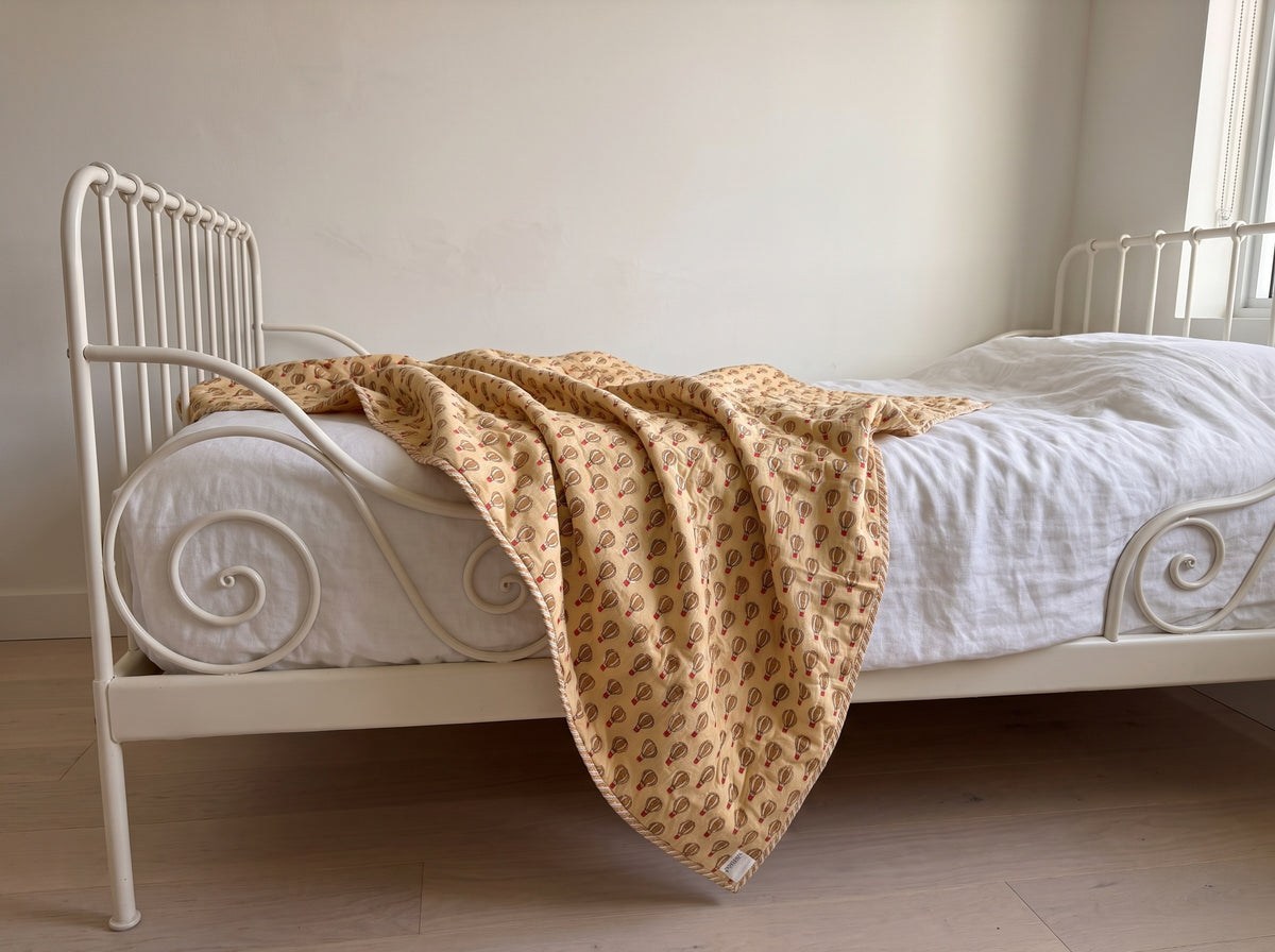 Balloon Adventures reversible cotton baby blanket, side one, iron bed
