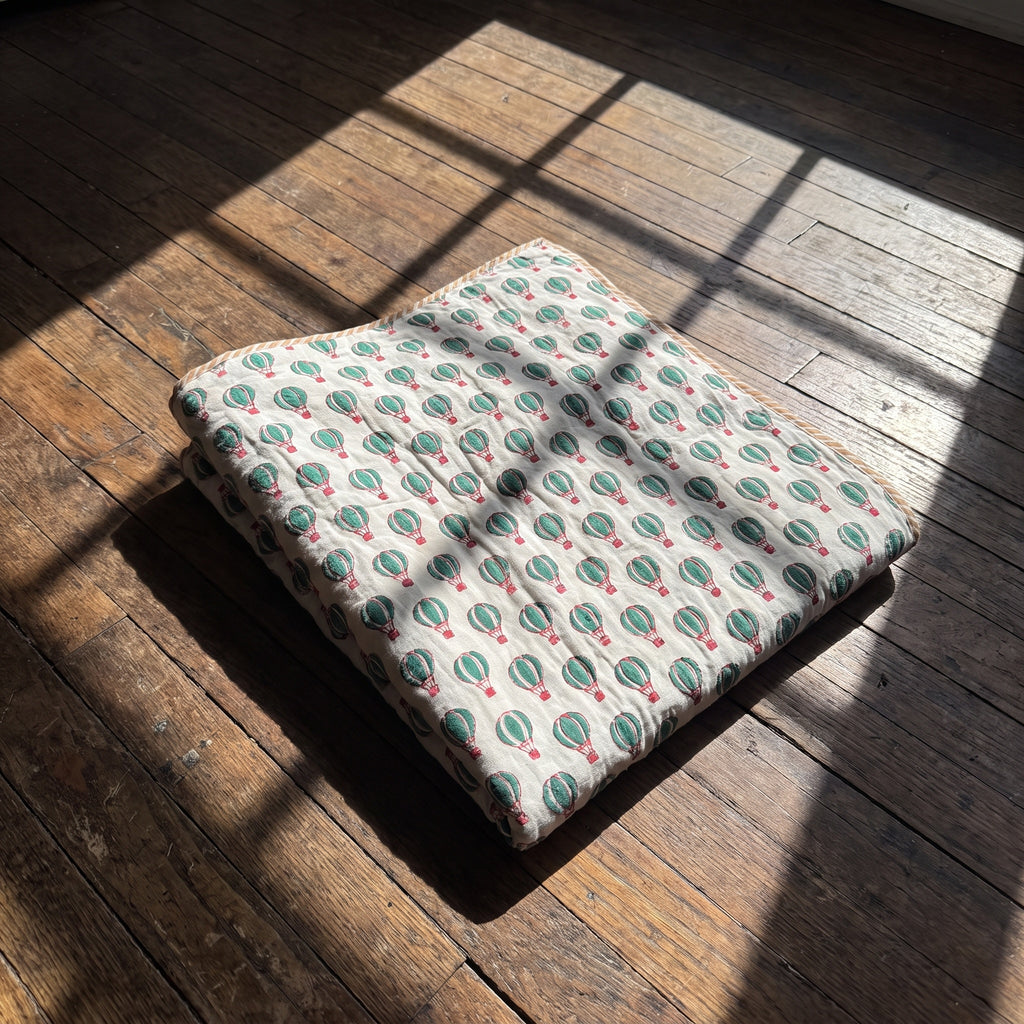 Balloon Adventures reversible cotton baby blanket, side two, floor