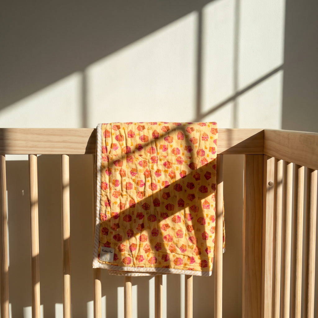 Storybook Friends reversible cotton baby blanket, side one, crib rail