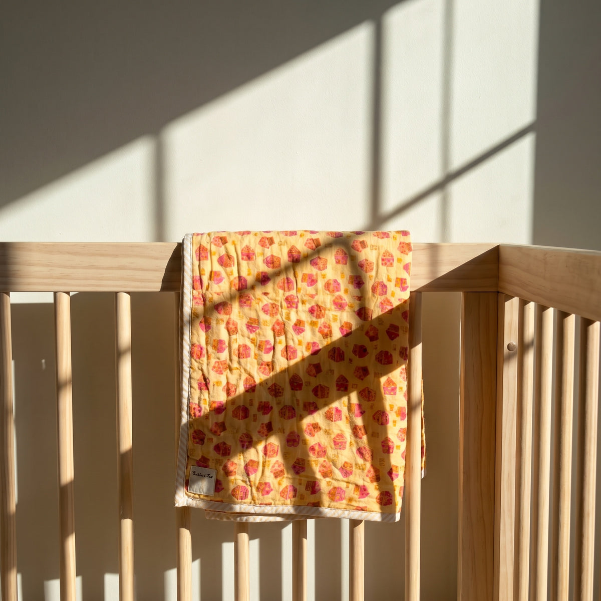 Storybook Friends reversible cotton baby blanket, side one, crib rail