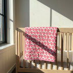 Berry Picnic reversible cotton baby blanket, side one, crib rail