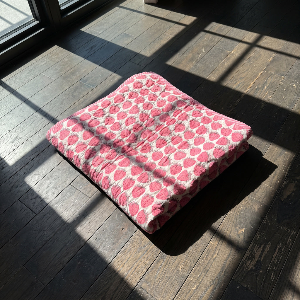 Berry Picnic reversible cotton baby blanket, side one, floor