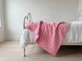 Berry Picnic reversible cotton baby blanket, side one, iron bed