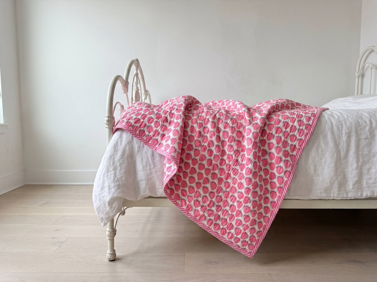 Berry Picnic reversible cotton baby blanket, side one, iron bed