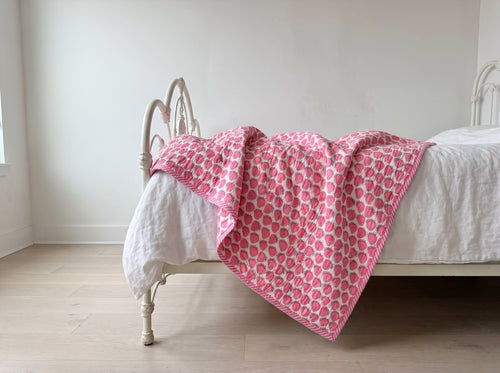 Berry Picnic reversible cotton baby blanket, side one, iron bed