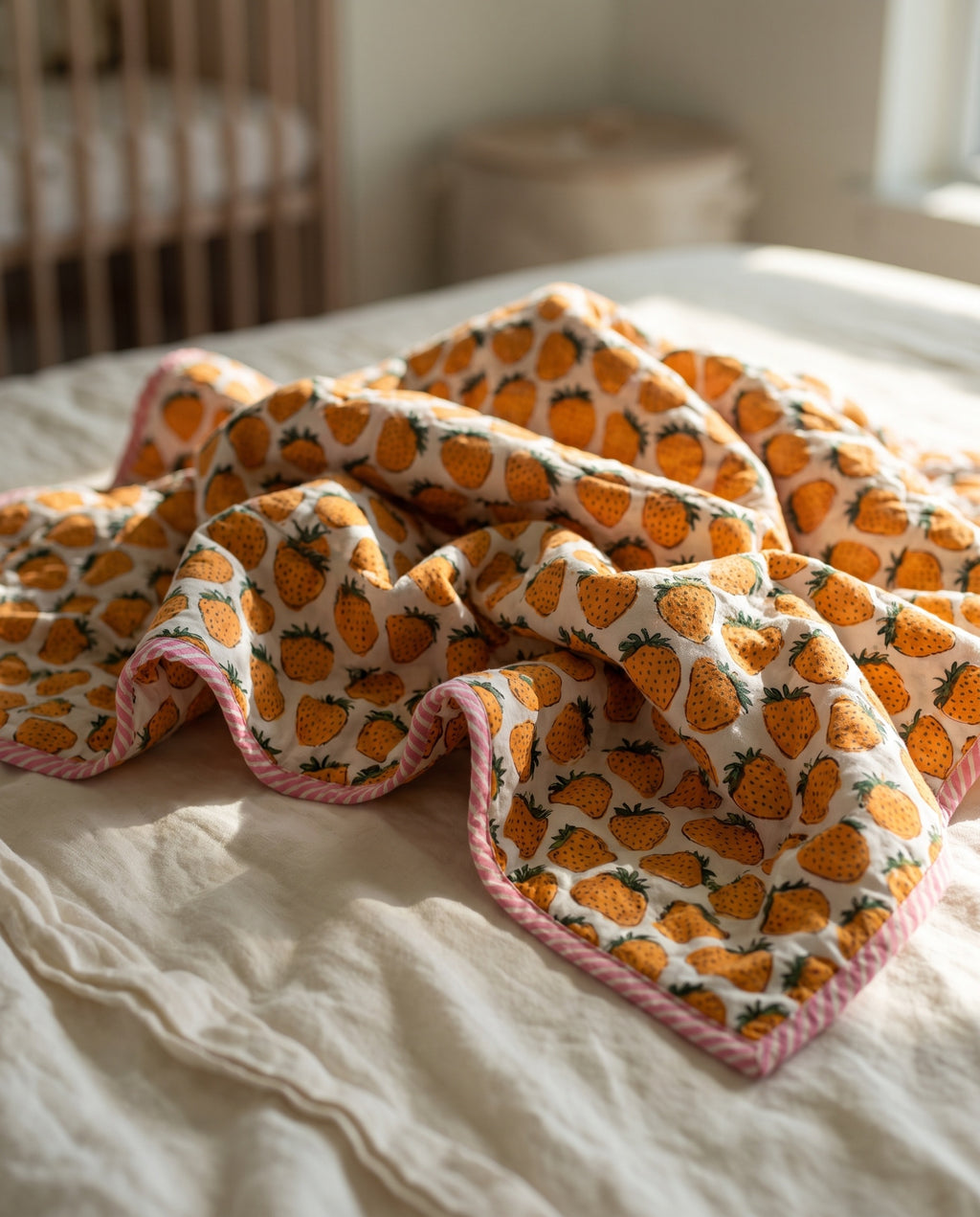 Berry Picnic reversible cotton baby blanket, side two, bed editorial