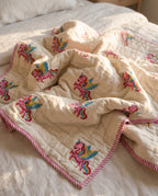 Unicorn Wishes reversible cotton baby blanket, side one, bed editorial