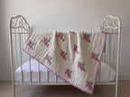 Unicorn Wishes reversible cotton baby blanket, side one, iron bed