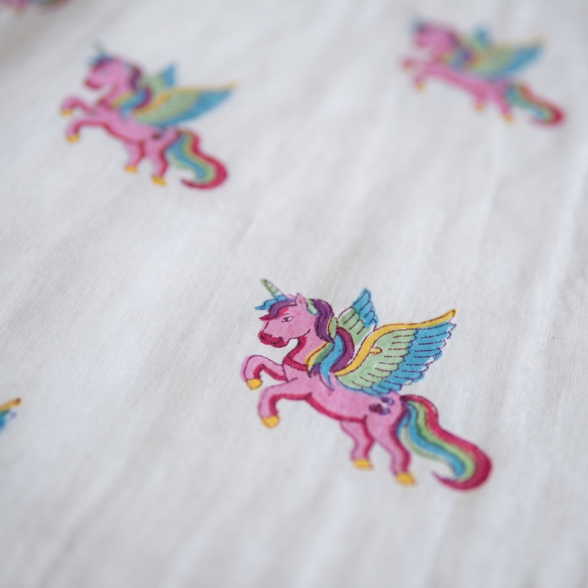 Unicorn Wishes reversible cotton baby blanket, side one, macro
