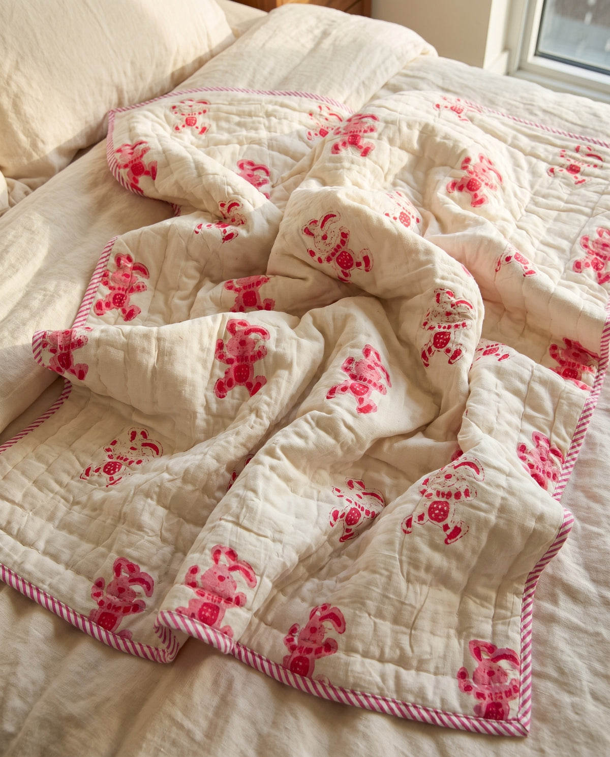 Unicorn Wishes reversible cotton baby blanket, side two, bed editorial