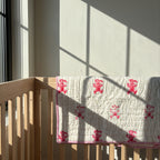 Unicorn Wishes reversible cotton baby blanket, side two, crib rail