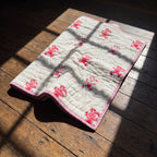 Unicorn Wishes reversible cotton baby blanket, side two, floor