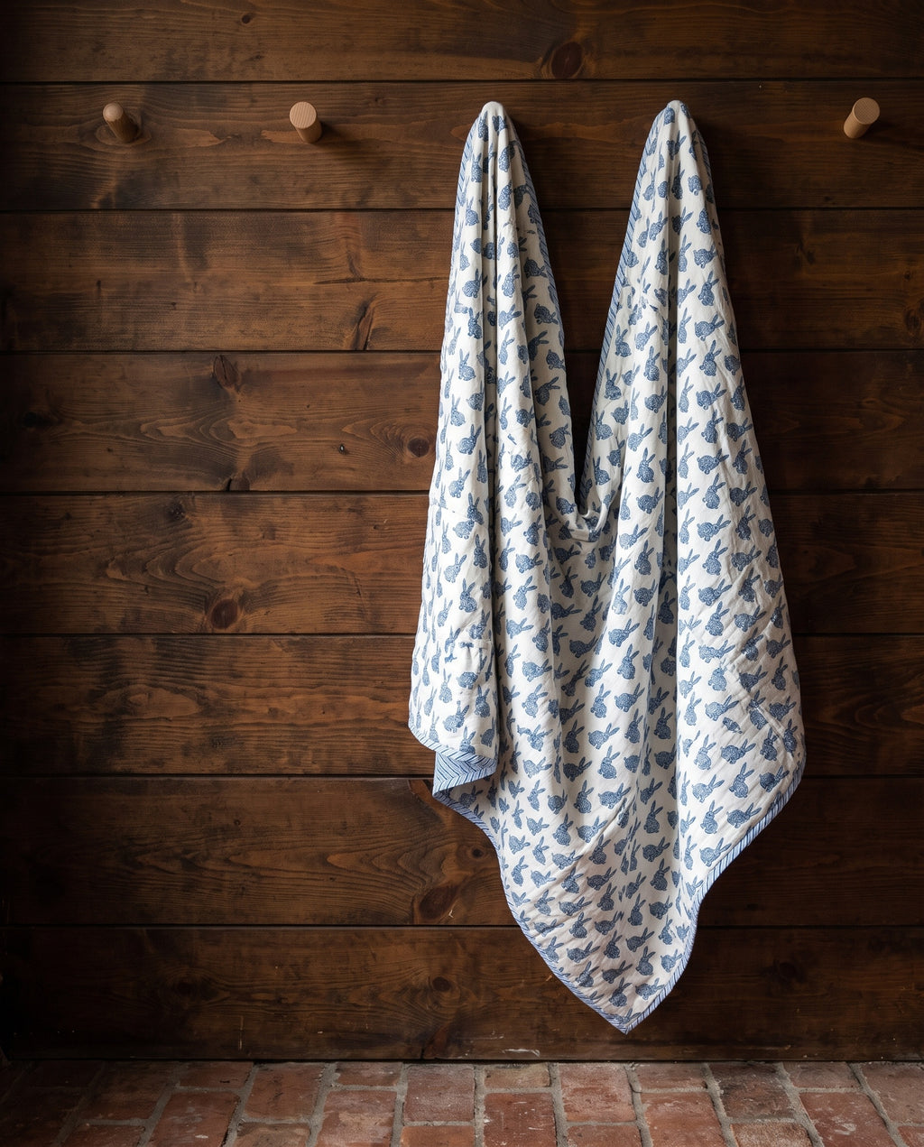 Bunny Trails reversible cotton baby blanket, side one, rustic pegs