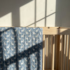 Bunny Trails reversible cotton baby blanket, side two, crib rail
