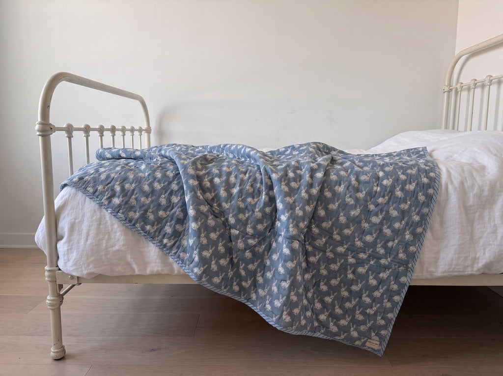 Bunny Trails reversible cotton baby blanket, side two, iron bed
