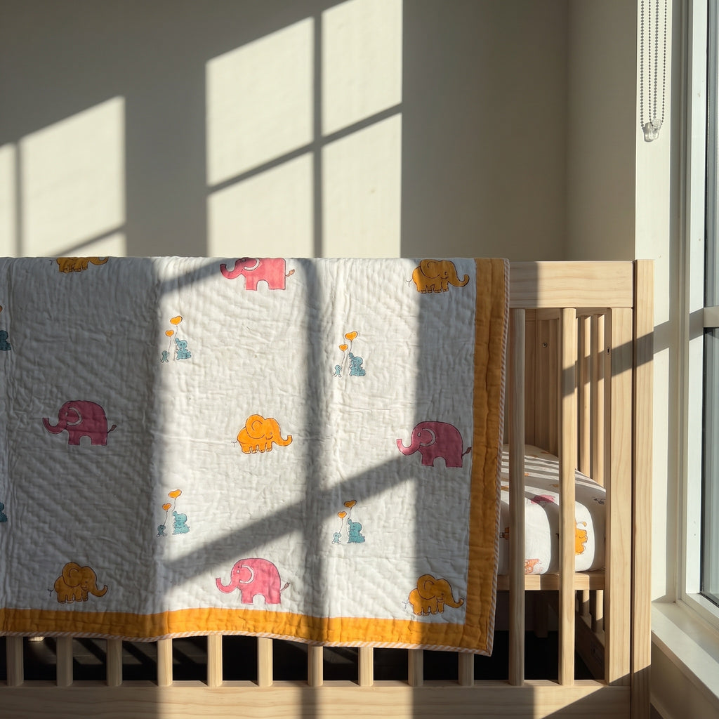 Elephant Wishes reversible cotton baby blanket, side one, crib rail