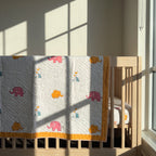 Elephant Wishes reversible cotton baby blanket, side one, crib rail