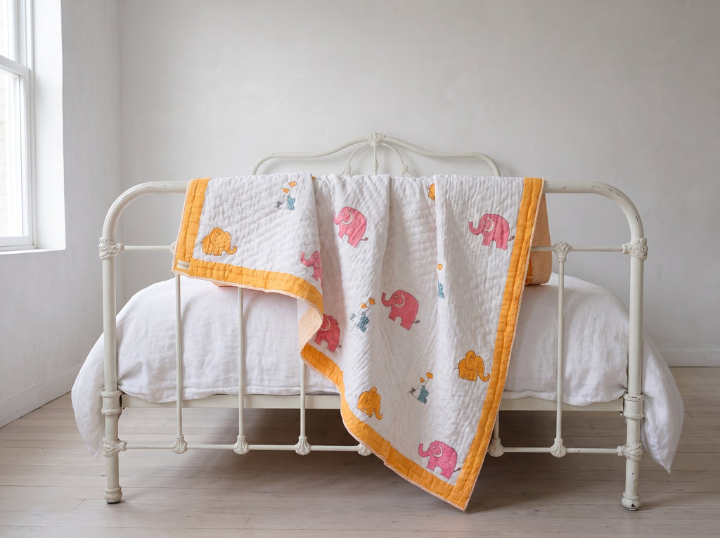Elephant Wishes reversible cotton baby blanket, side one, iron bed